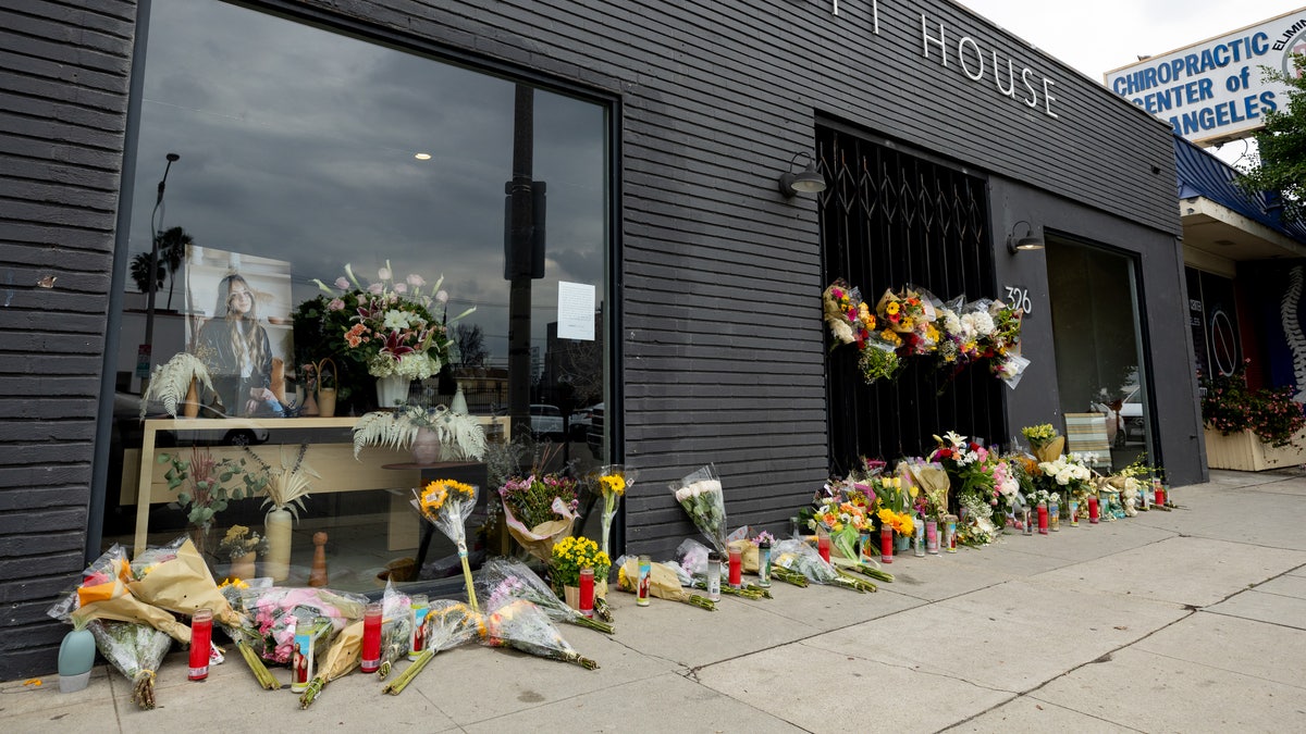 Flowers are placed outside Croft House furniture store in memory of graduate student Brianna Kupfer. Kupfer was stabbed to death 