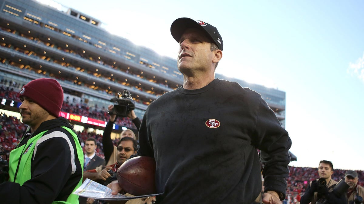 Jim Harbaugh runs off the field