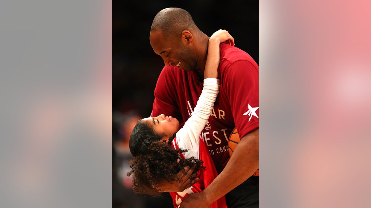 Kobe Bryant hugs his daughter, Gianna Bryant