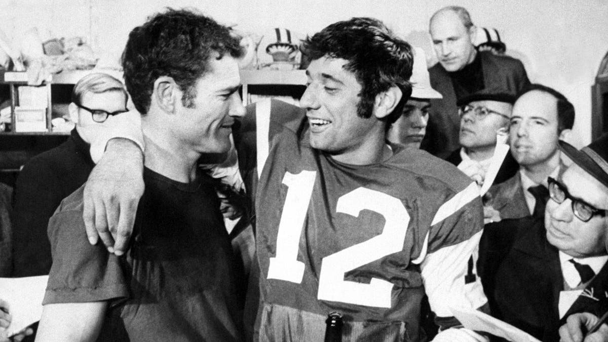 New York Jets' Joe Namath (right) and Don Maynard are surrounded by reporters after winning the AFL Championship, 27-23, over the Oakland Raiders.  