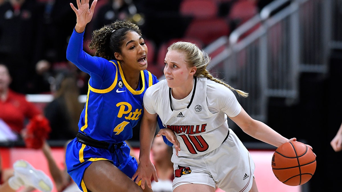 Louisville guard Hailey Van Lith (10) drives around Pittsburgh guard Emy Hayford (4) during the first half of an NCAA college basketball game in Louisville, Ky., Thursday, Jan. 6, 2022. Louisville won 81-39.