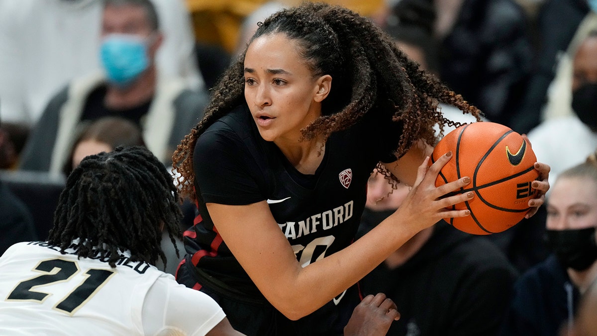 Stanford guard Haley Jones, right, looks to pass the ball as Colorado forward Mya Hollingshed defends in the first half of an NCAA college basketball game Friday, Jan. 14, 2022, in Boulder, Colo.