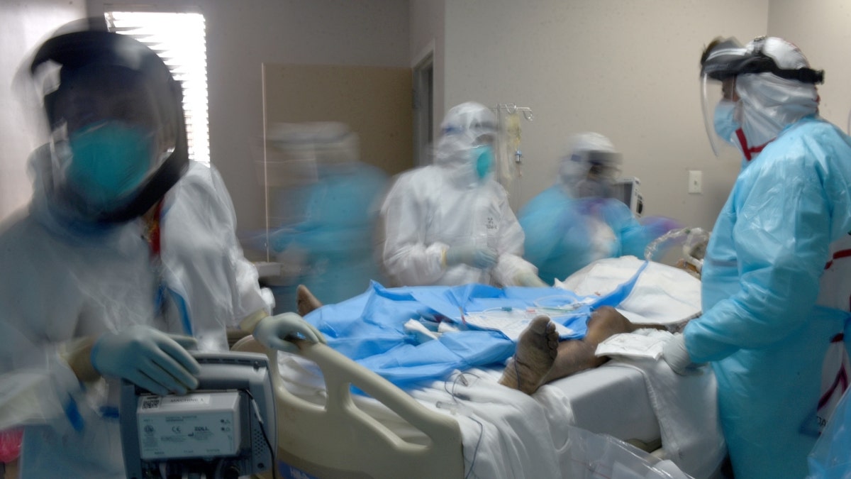 Healthcare workers treat a patient infected with the coronavirus disease (COVID-19) at United Memorial Medical Center in Houston, Texas, U.S., December 29, 2020.