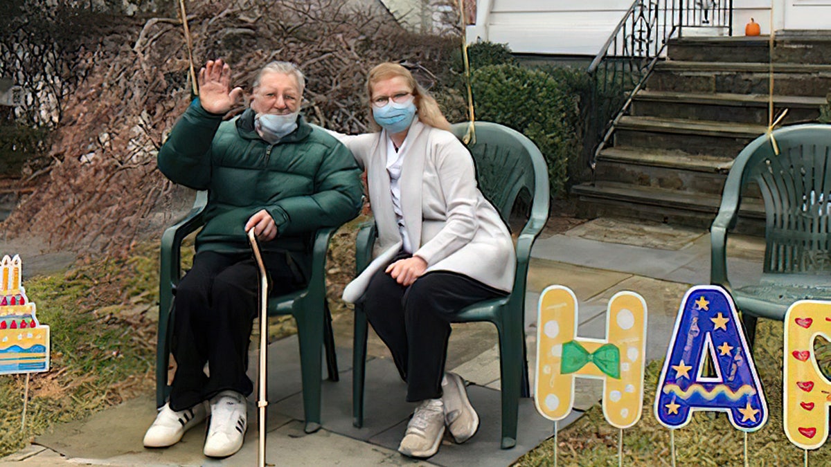 WWII veteran Stanley Tauber of New York (left) celebrated his 102nd birthday on Dec. 31, 2021 — and friends and community members came by to support him. He's shown above in the front yard of his home, with his daughter, Carol DeAngelis, on his birthday.