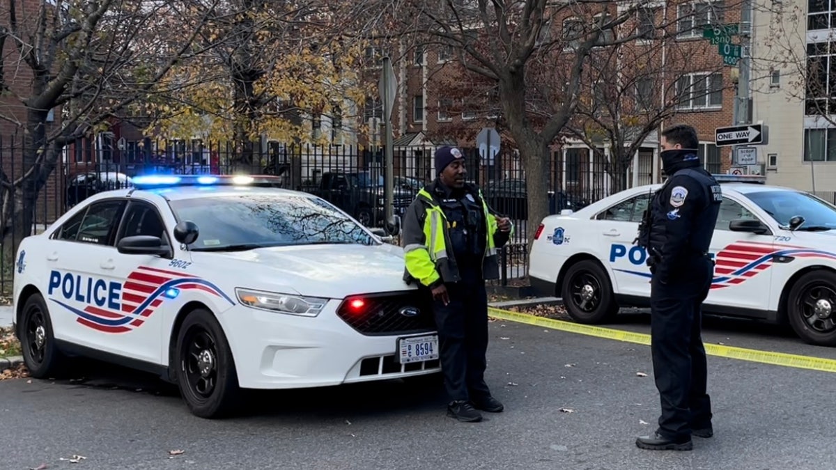 Metropolitan Police Department officers chatting by squad cars. (Fox News/Ethan Barton)