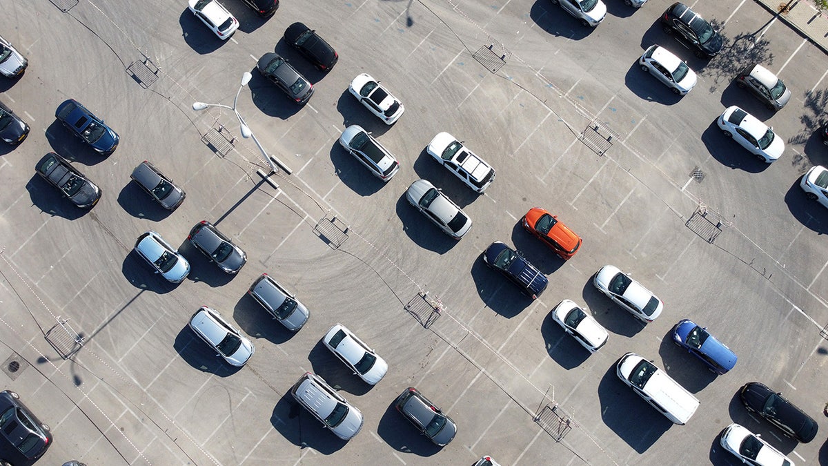In this aerial view, people wait in their cars to be tested for coronavirus at a drive-in testing site on January 6, 2022 in Petah Tikva, Israel. (Photo by Amir Levy/Getty Images)