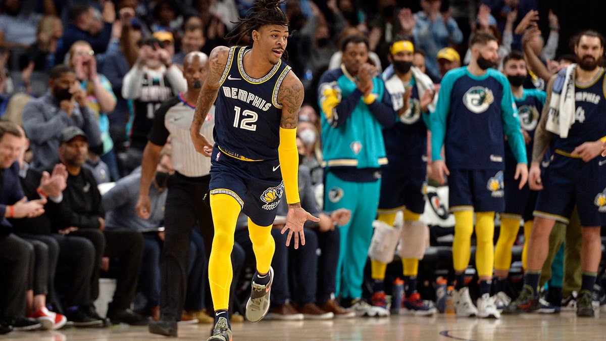 Memphis Grizzlies guard Ja Morant (12) reacts in the second half of an NBA basketball game against the Utah Jazz Friday, Jan. 28, 2022, in Memphis, Tenn.