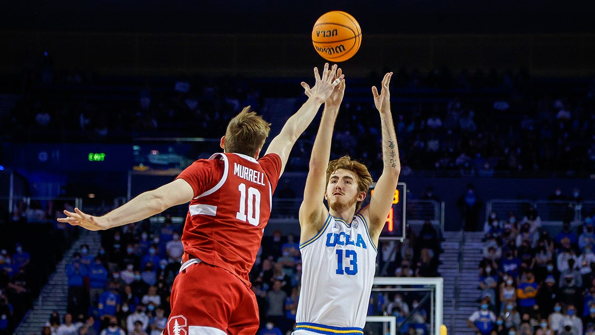 UCLA guard Jake Kyman (13) shoots against Stanford forawrd Max Murrell (10) in the second half of an NCAA college basketball game Saturday, Jan. 29, 2022, in Los Angeles.