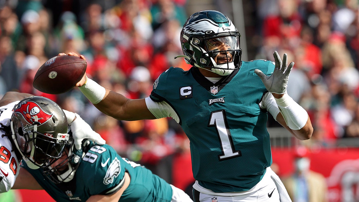 Philadelphia Eagles quarterback Jalen Hurts (1) throws a pass against the Tampa Bay Buccaneers during the first half of an NFL wild-card football game Sunday, Jan. 16, 2022, in Tampa, Fla. 