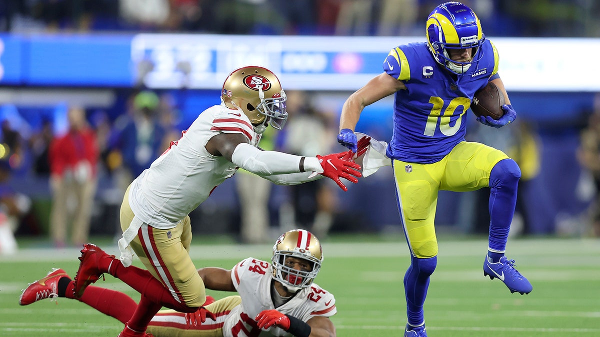 Los Angeles Rams' Cooper Kupp (10) gets past San Francisco 49ers' Jaquiski Tartt, left, and K'Waun Williams (24) during the second half of the NFC Championship NFL football game Sunday, Jan. 30, 2022, in Inglewood, Calif.