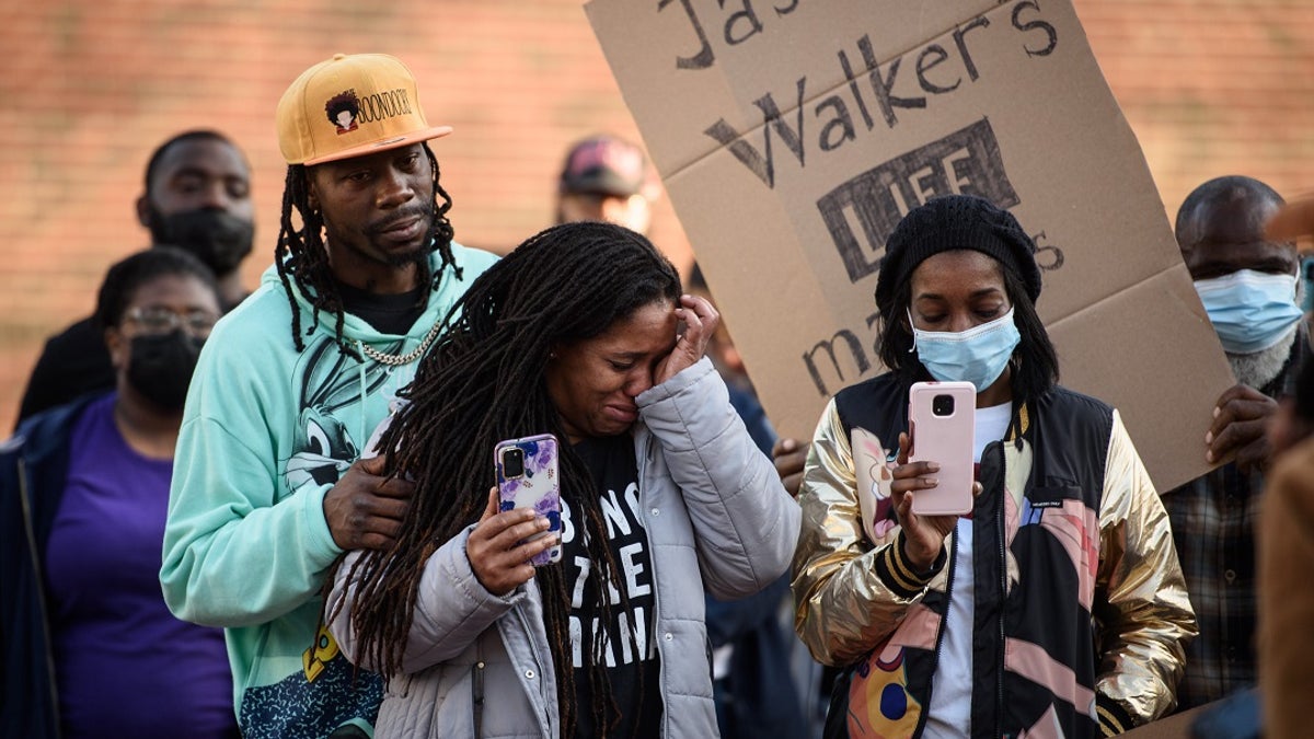 Demonstrators get emotional during a Justice for Jason Walker demonstration in front of the Fayetteville Police Dept. on Sunday, Jan. 9, 2022.