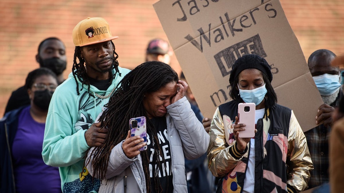 Demonstrators get emotional during a Justice for Jason Walker demonstration in front of the Fayetteville Police Dept. on Sunday, Jan. 9, 2022.