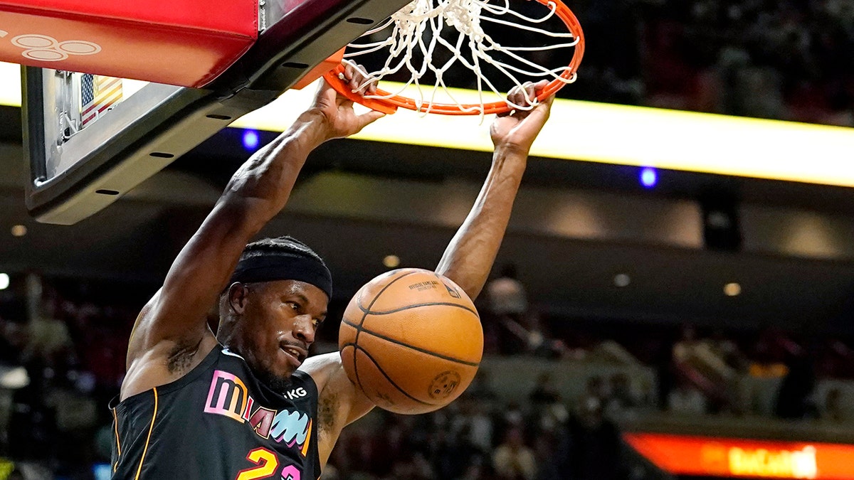 Miami Heat forward Jimmy Butler (22) dunks during the first half of an NBA basketball game against the Los Angeles Clippers, Friday, Jan. 28, 2022, in Miami.