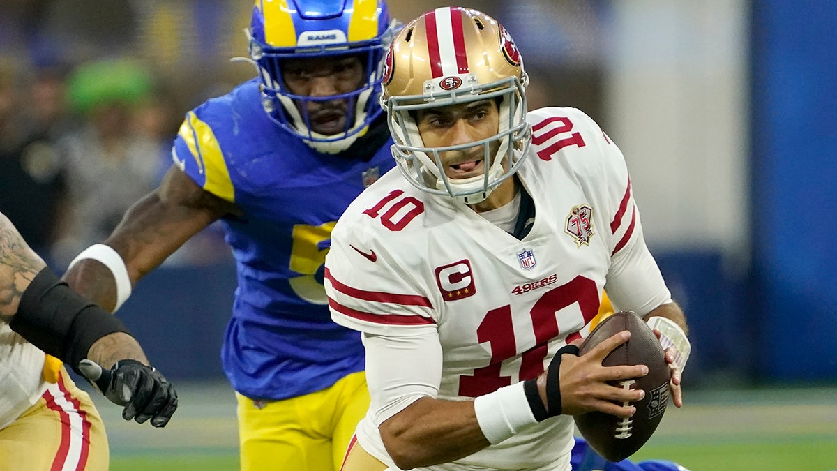 San Francisco 49ers' Jimmy Garoppolo (10) scrambles during the first half of the NFC Championship NFL football game against the Los Angeles Rams Sunday, Jan. 30, 2022, in Inglewood, Calif.