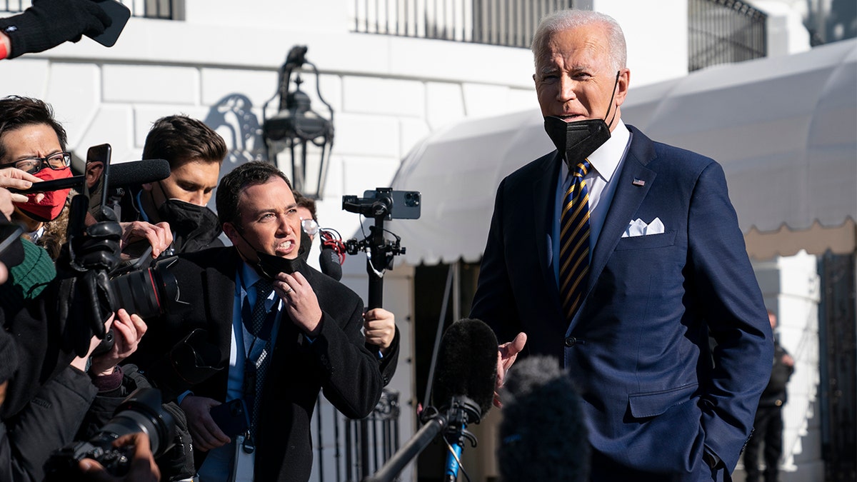 President Biden talks to reporters before boarding Marine One on the South Lawn of the White House, Tuesday, Jan. 11, 2022, in Washington. 