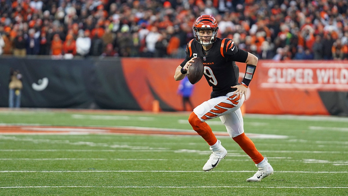 Cincinnati Bengals quarterback Joe Burrow (9) looks to throw during the first half of an NFL wild-card playoff football game against the Las Vegas Raiders, Saturday, Jan. 15, 2022, in Cincinnati.