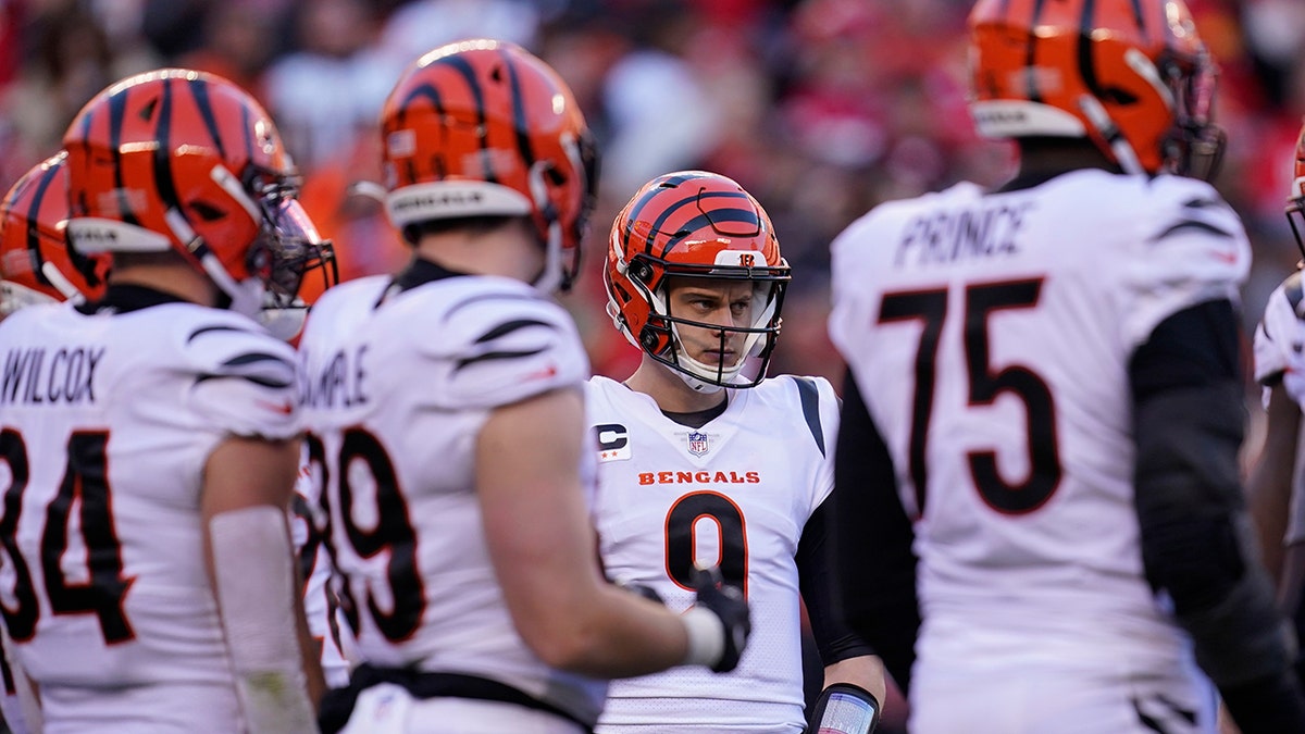 Cincinnati Bengals quarterback Joe Burrow (9) calls a play in the huddle during the second half of the AFC championship NFL football game against the Kansas City Chiefs, Sunday, Jan. 30, 2022, in Kansas City, Mo.