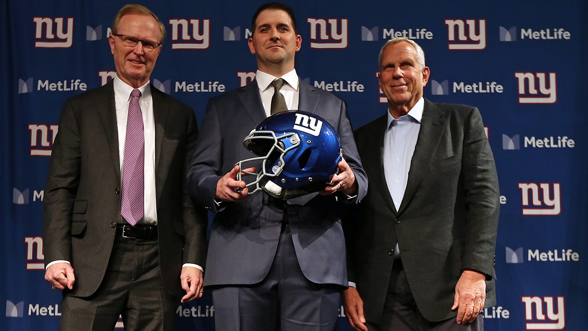 New York Giants new head coach Joe Judge, center, poses for photographs with team CEO John Mara, left, chairman and executive vice president Steve Tisch, right, after a news conference at MetLife Stadium on Jan. 9, 2020, in East Rutherford, New Jersey.