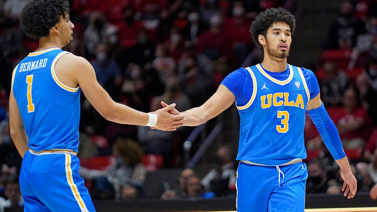 UCLA's Jules Bernard (1) congratulates Johnny Juzang (3), who scored against Utah during the first half of an NCAA college basketball game Thursday, Jan. 20, 2022, in Salt Lake City.