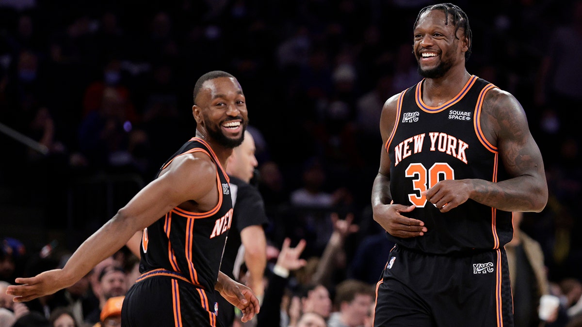 New York Knicks forward Julius Randle (30) and Kemba Walker react during the second half of an NBA basketball game against the Atlanta Hawks on Saturday, Dec. 25, 2021, in New York.