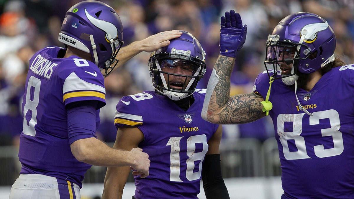 Minnesota Vikings quarterback Kirk Cousins congratulates wide receiver Justin Jefferson