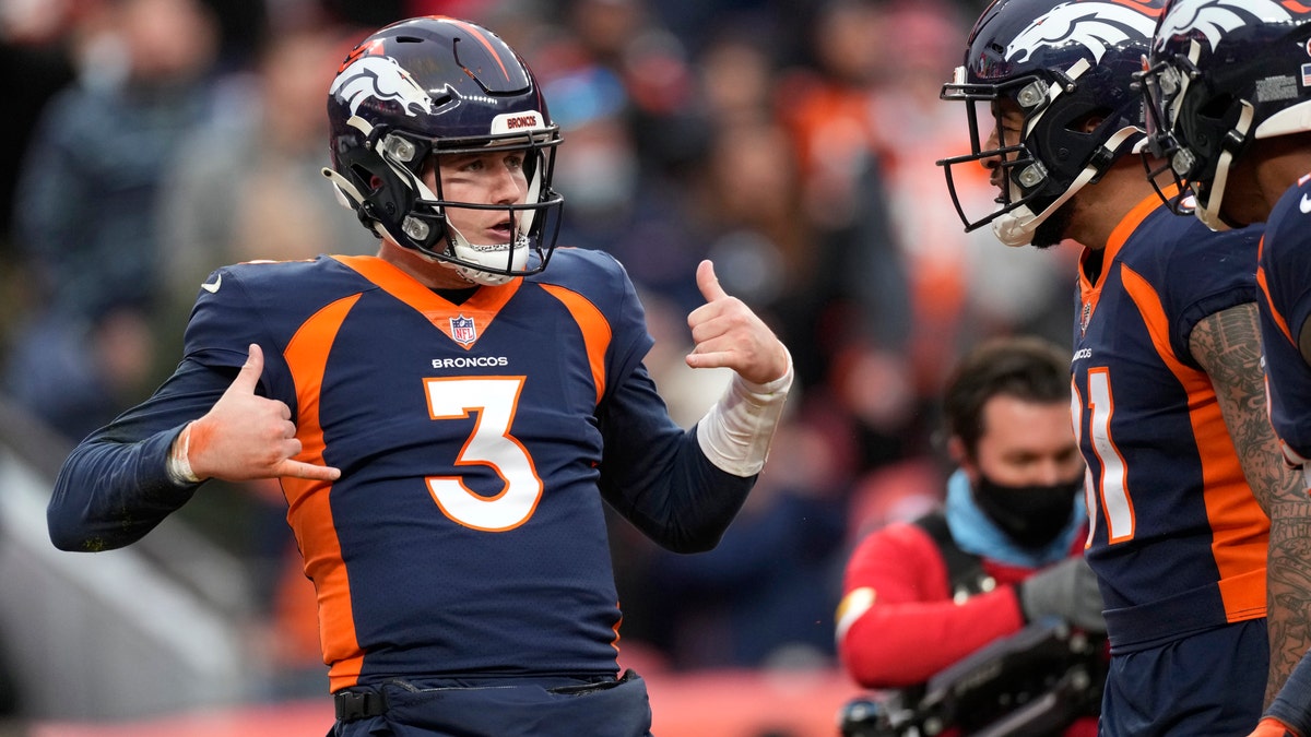 Denver Broncos quarterback Drew Lock (3) celebrates with teammates after scoring against the Kansas City Chiefs during the first half of an NFL football game Saturday, Jan. 8, 2022, in Denver. (AP Photo/David Zalubowski)