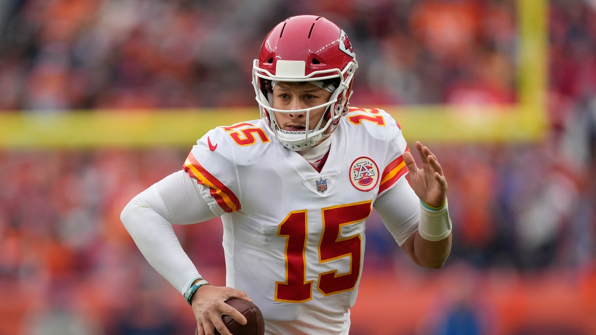 Kansas City Chiefs quarterback Patrick Mahomes (15) scrambles against the Denver Broncos during the first half of an NFL football game Saturday, Jan. 8, 2022, in Denver. 