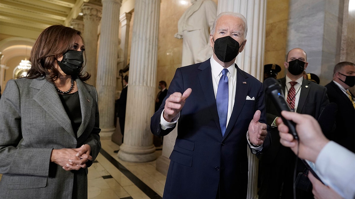 President Biden and Vice President Kamala Harris speak to reporters as they prepare to depart the U.S. Capitol after marking one year since the Jan. 6 riot at the Capitol by supporters loyal to then-President Trump, Thursday, Jan. 6, 2022, in Washington. 