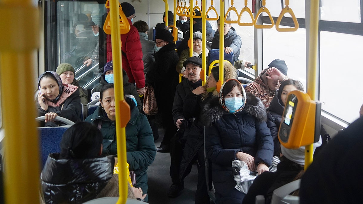 People ride a municipal bus in Almaty, Kazakhstan, Monday, Jan. 10, 2022. 