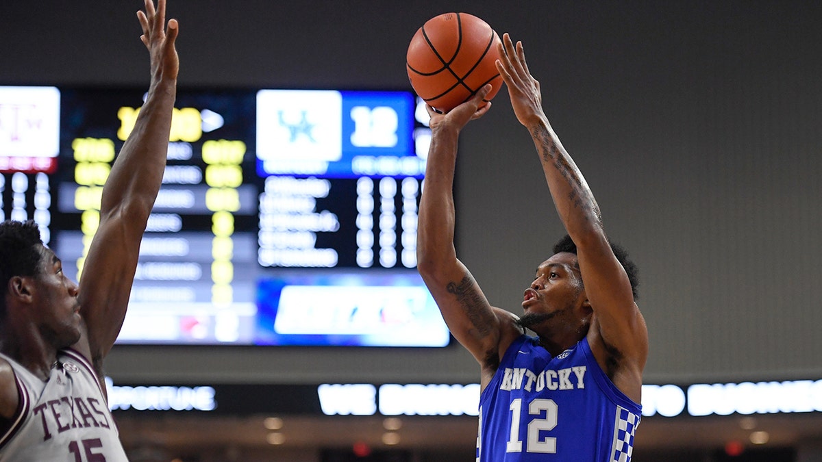 Kentucky forward Keion Brooks Jr. (12) shoots over Texas A&amp;M forward Henry Coleman III (15) during the first half of an NCAA college basketball game Wednesday, Jan. 19, 2022, in College Station, Texas.