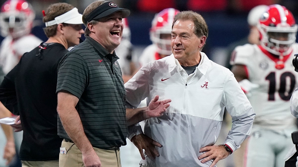 FILE - Georgia head coach Kirby Smart speaks with Alabama head coach Nick Saban before the first half of the Southeastern Conference championship NCAA college football game, Saturday, Dec. 4, 2021, in Atlanta. Georgia plays Alabama in the College Football Playoff national championship game on Jan. 10, 2022. 