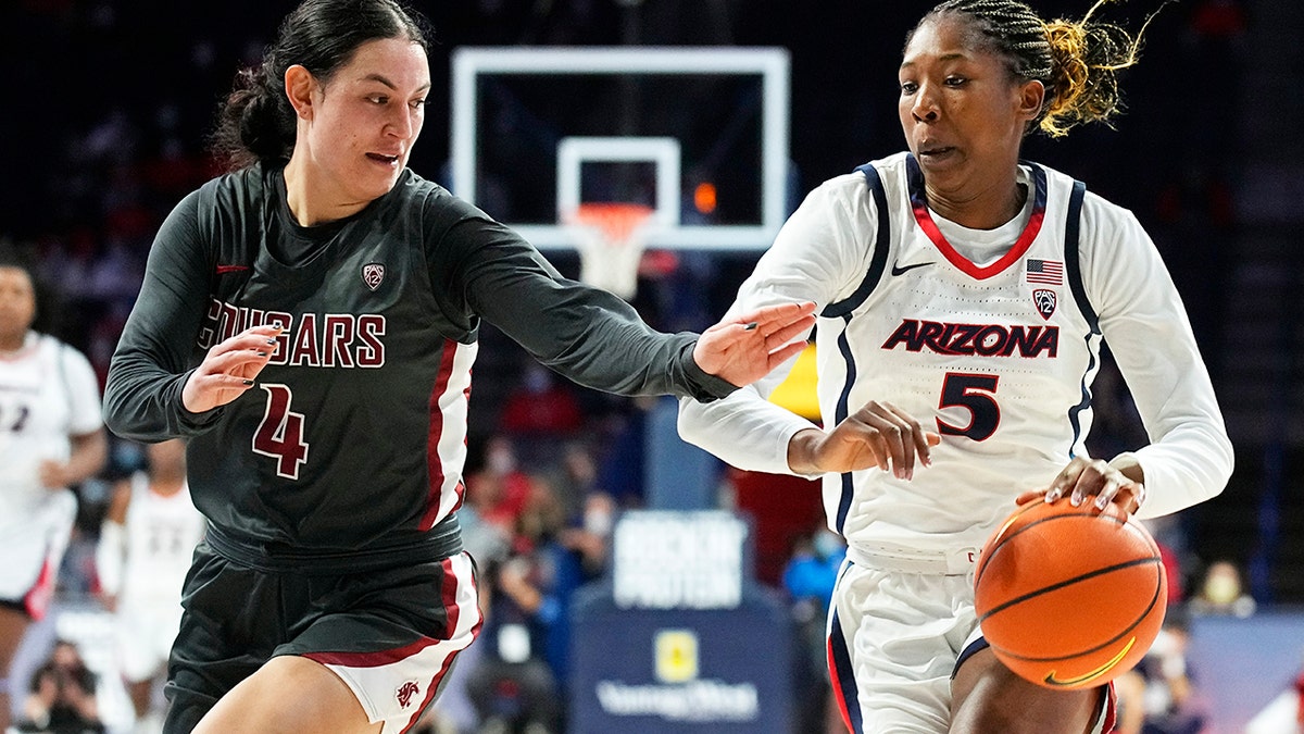 Arizona forward Koi Love (5) drives past Washington State guard Krystal Leger-Walker during the first half of an NCAA college basketball game Friday, Jan. 7, 2022, in Tucson, Ariz.