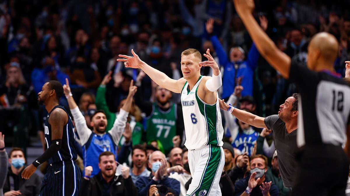 Dallas Mavericks forward Kristaps Porzingis (6) celebrates a three-point basket at the buzzer at the end of the first quarter of an NBA basketball game against the Orlando Magic, Saturday, Jan. 15, 2022, in Dallas.