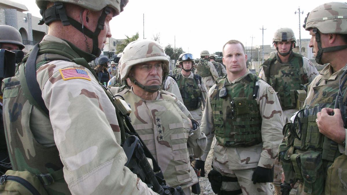 BAGHDAD, IRAQ: General George Casey (2nd L), commander of US troops arrives at a military combat outpost manned by soldiers from the 1st Battalion, 24th Infantry Regiment in the restive northern city of Mosul 27 January 2005. The commander of the battalion Lieutenant Colonel Michael Kurilla is first starting from right. FP PHOTO/SAM DAGHER (Photo credit should read SAM DAGHER/AFP via Getty Images)