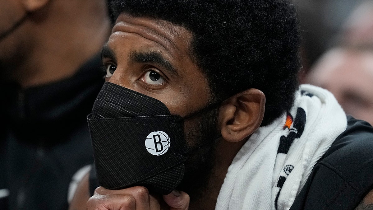 Brooklyn Nets' Kyrie Irving watches from the bench during the first half of the team's NBA basketball game against the Indiana Pacers, Wednesday, Jan. 5, 2022, in Indianapolis.