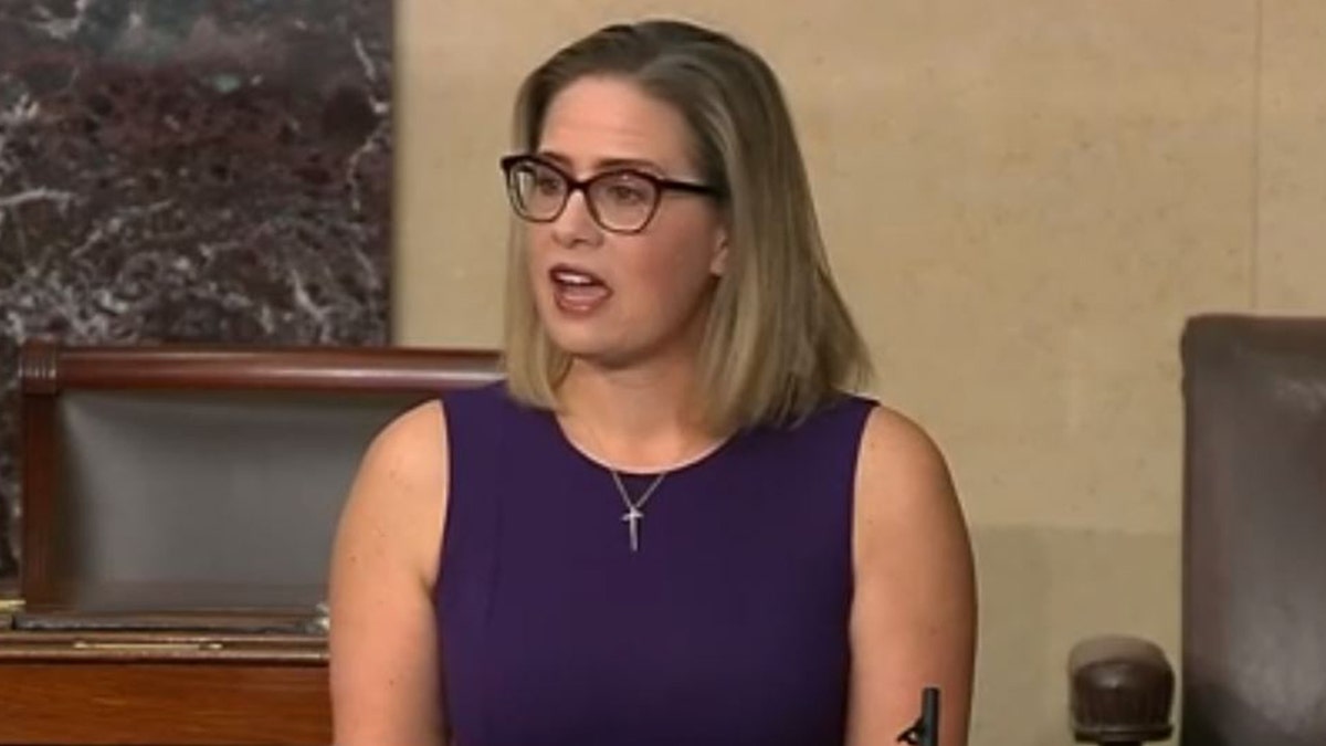 Sen. Kyrsten Sinema, D-Ariz., delivers remarks on the Senate floor in support of the legislative filibuster, on Thursday, Jan. 13, 2022. 