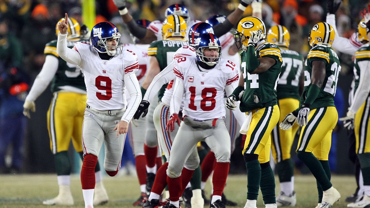 Kicker Lawrence Tynes #9 of the New York Giants celebrates after kicking the game winning 47-yard field goal to win the NFC championship game against the Green Bay Packers on Jan. 20, 2008 at Lambeau Field in Green Bay, Wisconsin.   The Giants defeated the Packers 23-20 in overtime to advance to the Superbowl XLII.