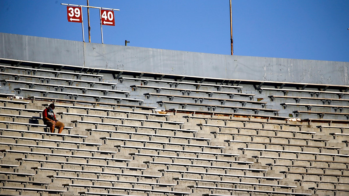 A lone fan sits in the stands waiting the kickoff between UAB and Central Arkansas before an NCAA college football game at Legion Field Sept. 3, 2020, in Birmingham, Alabama.
