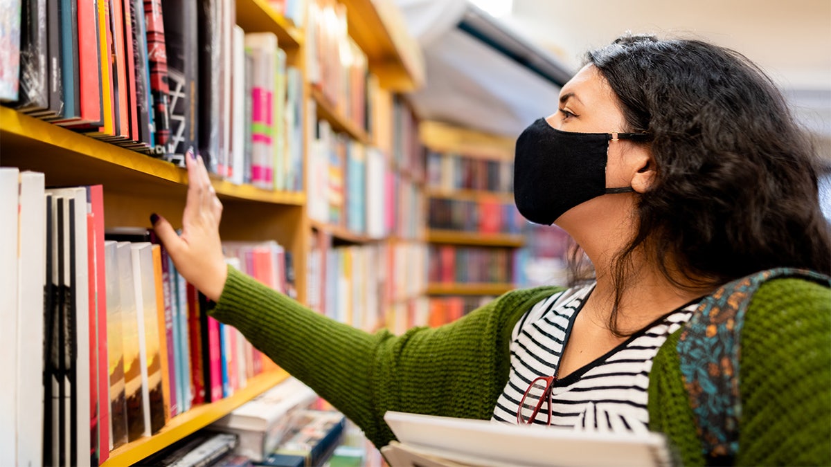 masked person in library