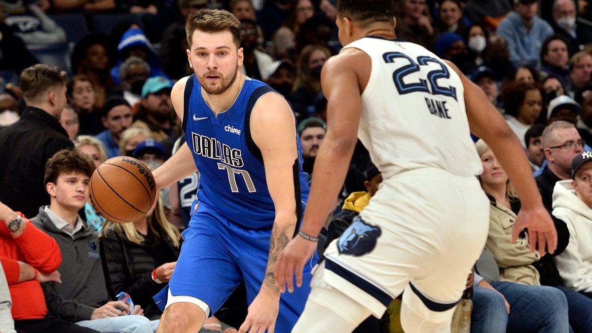 Dallas Mavericks guard Luka Doncic (77) handles the ball against Memphis Grizzlies guard Desmond Bane (22) in the second half of an NBA basketball game Friday, Jan. 14, 2022, in Memphis, Tenn.