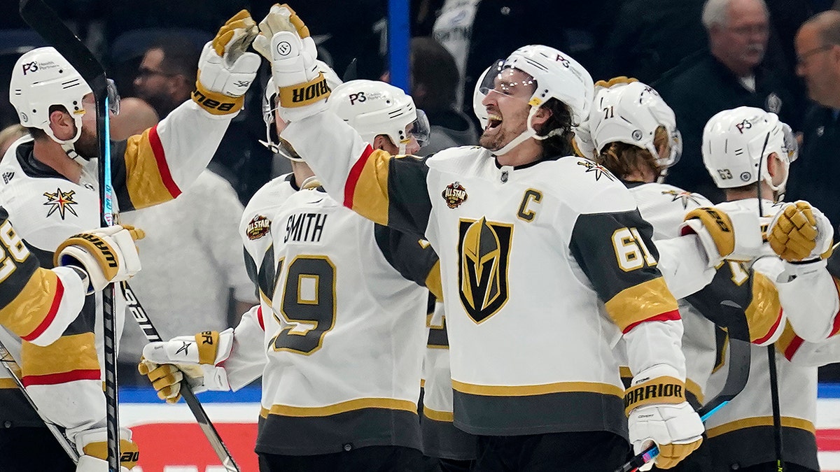 Vegas Golden Knights right wing Mark Stone (61) celebrates with teammates after scoring the game-winning goal during a shoot out against the Tampa Bay Lightning during an NHL hockey game Saturday, Jan. 29, 2022, in Tampa, Fla.