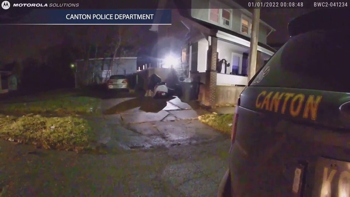 Still of body camera footage showing Marquetta Williams emerge from her home with her hands up after a cop shot her husband