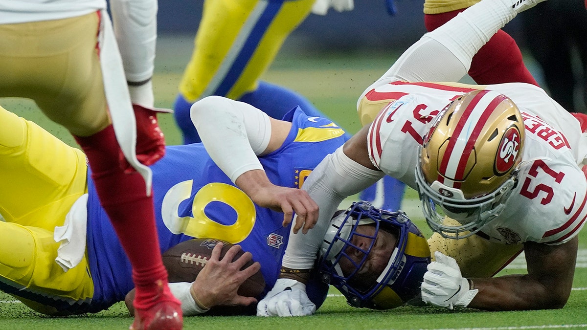 The San Francisco 49ers' Dre Greenlaw (57) stops the Los Angeles Rams' Matthew Stafford during the first half of the NFC Championship NFL football game Sunday, Jan. 30, 2022, in Inglewood, California.