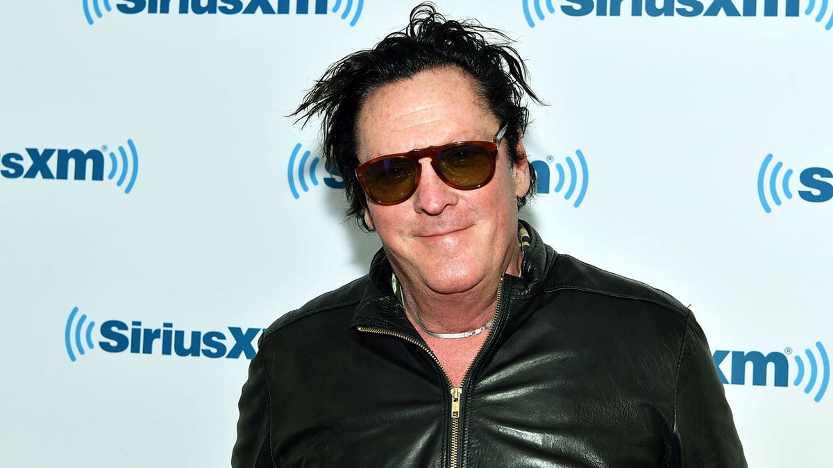 Michael Madsen with sunglasses on posing on a red carpet
