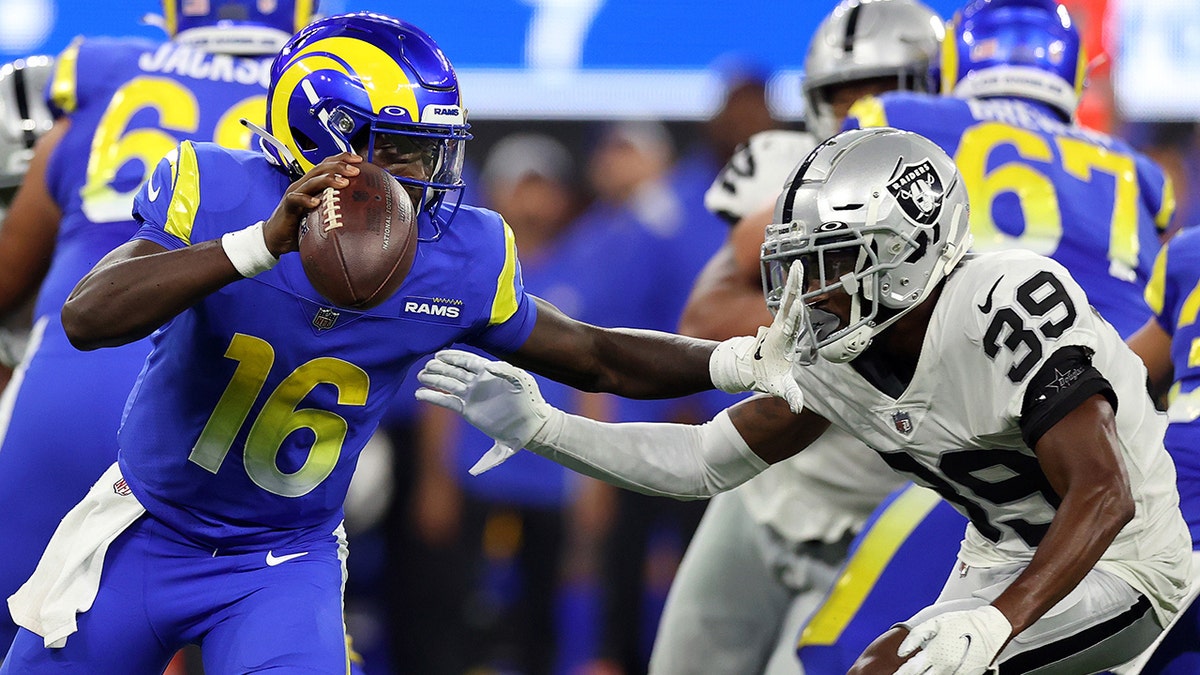 Bryce Perkins #16 of the Los Angeles Rams looks to pass against Nate Hobbs #39 of the Las Vegas Raiders in the first half at SoFi Stadium on August 21, 2021 in Inglewood, California. 