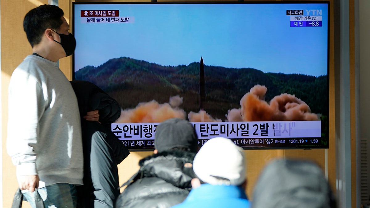 People watch a TV screen showing a news program reporting about North Korea's missile launch with a file footage at a train station in Seoul. (AP Photo/Lee Jin-man)