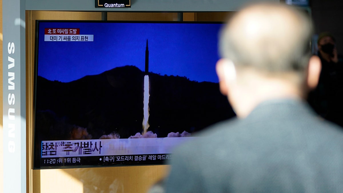 A man watches a TV screen showing a news program reporting about North Korea's missile launch with a file image, at a train station in Seoul, South Korea, Monday, Jan. 17, 2022. (AP Photo/Lee Jin-man)
