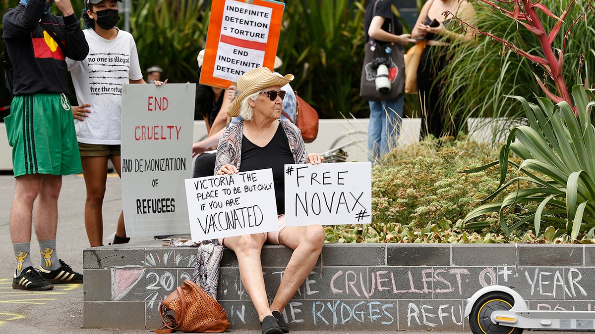 A tennis fan holds a sign outside the Park Hotel in Carlton on January 06, 2022 in Melbourne, Australia.