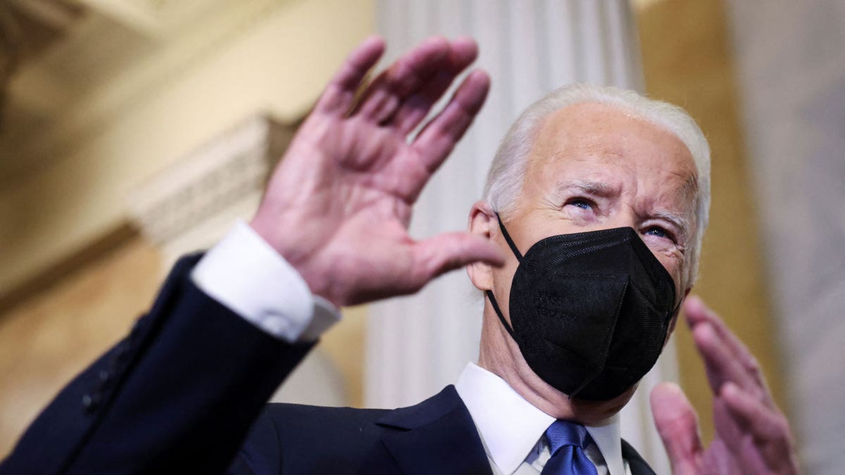 President Biden talks to reporters as he departs through the Hall of Columns following his speech to mark the first year after the Jan. 6, 2021, attack on the U.S. Capitol by supporters of former President Trump, on Capitol Hill in Washington, Jan. 6, 2022.