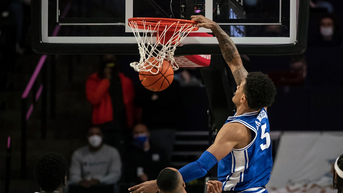 Duke forward Paolo Banchero (5) slam dunks over Wake Forest forward Dallas Walton (13) during the first half of an NCAA college basketball game on Wednesday, Jan. 12, 2022, in Winston-Salem, N.C.